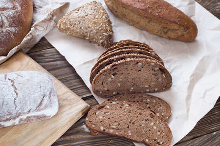 Different bread on table close-up. healthy bread on wooden background, craft paper.