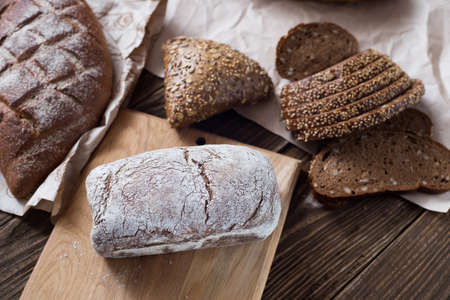 Different bread on table close-up. healthy bread on wooden background, craft paper.