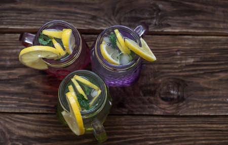lemonade in jar with ice and mint, different colors of jarsの写真素材