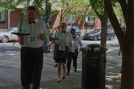 PORTLAND, OREGON/USA - JULY 13, 2019 : Competitors round a corner during the Waitersâ€™ Race at...