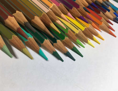 Return back to school. Close up of colored sharpened pencils on white background. Colorful conceptの写真素材