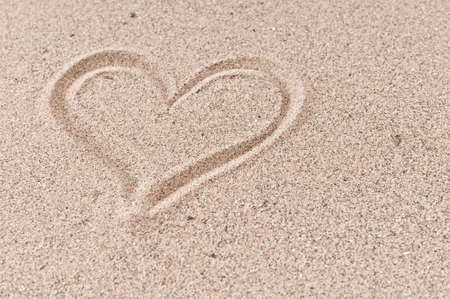 Holiday love concept  heart in the beach sandの写真素材
