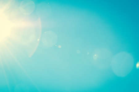 Sunshine and blue sky with flares in summerの写真素材