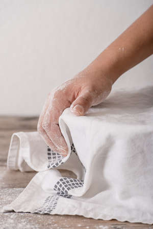 Baking at home - covering a bowl of paste with a white towel