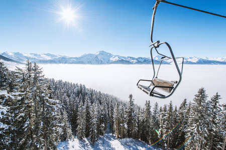 Ski lift and snow covered winter mountainsの写真素材