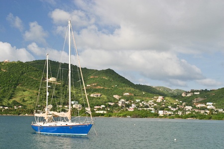 A sailboat is anchored in the harbor of Belle Vue on the British Virgin Island of Jost Van Dyke.のeditorial素材