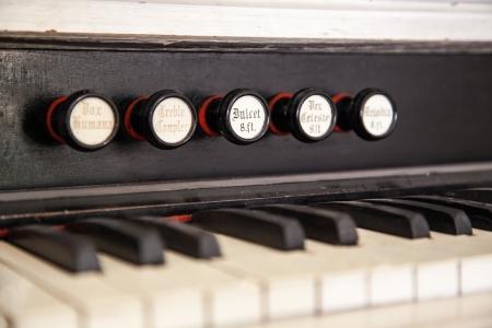 Closeup of an antique pump organ with its stops and keys の写真素材