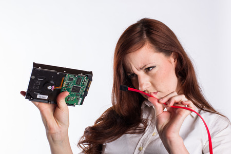 Woman Examines Hard Drive Connector