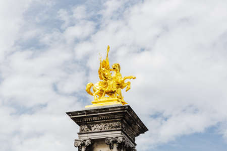 gold colored sculpture on the top of stone pillar.The Alexander III bridge sculpture detailのeditorial素材
