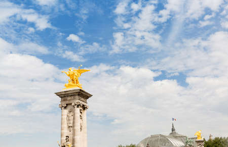 gold colored sculpture on the top of stone pillar.The Alexander III bridge sculpture detailのeditorial素材
