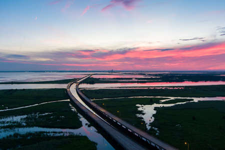 Aerial view of the Jubilee Parkway bridge on Mobile Bay at sunset in July 2022