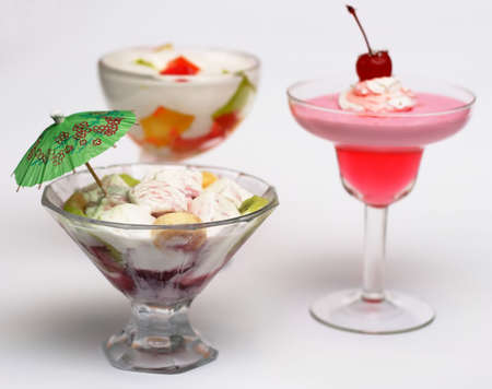 Three tasty cold desserts with ice-cream and fruitの写真素材