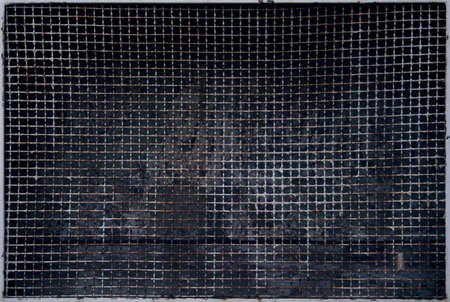 Rusty metal grate background with a moth sitting on itの写真素材