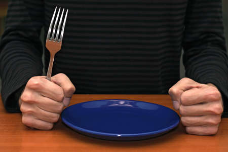 Hands of an angry customer waiting for his mealの写真素材