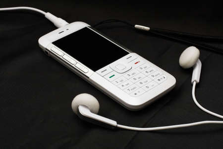 White mobile phone on black backgroundの写真素材