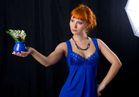 Beautiful lady smelling flowersの写真素材