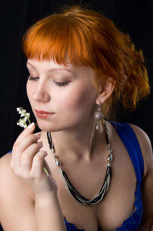 Beautiful lady smelling flowersの写真素材