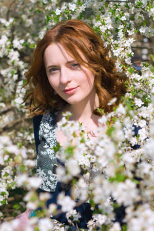Beautiful girl in a spring gardenの写真素材