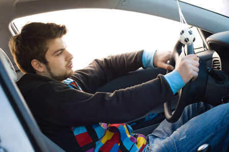 Young man driving a carの写真素材