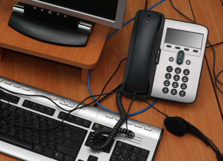 Digital phone and computer lying in a messの写真素材