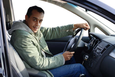 Young driver sitting in his new carの写真素材