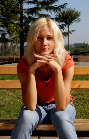 Beautiful girl in a park, looking at cameraの写真素材