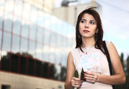 Young beautiful woman on a cityscape backgroundの写真素材
