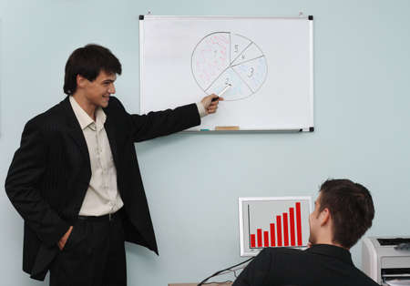 Two buisnessmen discussing the growth diagram on a meeting Two buisnessmen discussing the growth diagram on a meeting