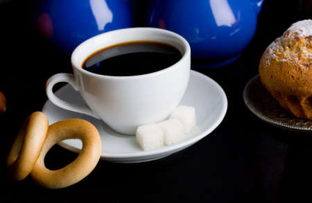 Coffee with pastry on black backgroundの写真素材