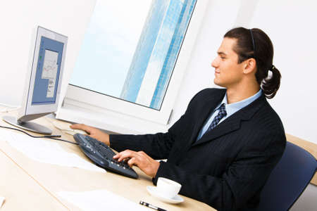 Successful businessman working at the computer in his officeの写真素材