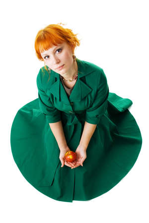 Beautiful lady holding an apple, white backgroundの写真素材