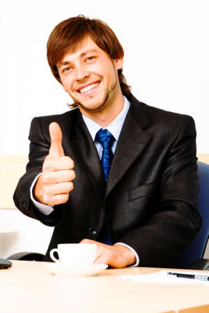 Successful businessman showing thumbs upの写真素材