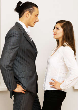 Young businessman and woman having an argument in officeの写真素材