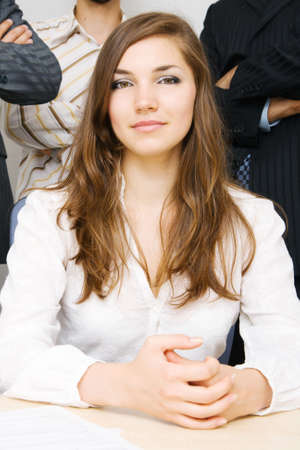 Young successful businesswoman, with her team on backgroundの写真素材