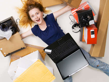 Young girl surrounded with her delivered online ordersの写真素材
