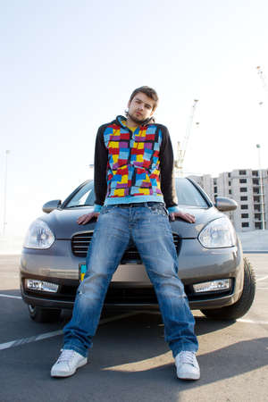 Handsome man standing near his new car の写真素材