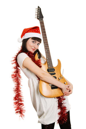 Joyful christmas girl with an electric guitarの写真素材