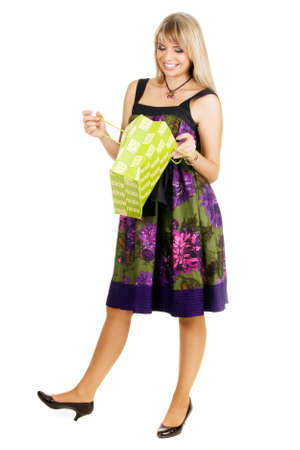 Young beautiful lady looking into a shopping bagの写真素材