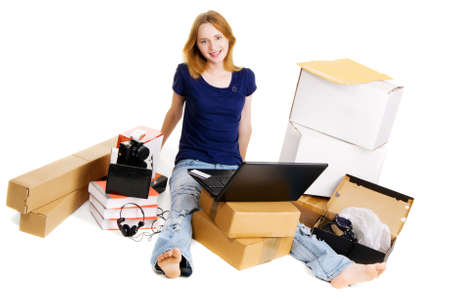 Young girl surrounded with her delivered online ordersの写真素材