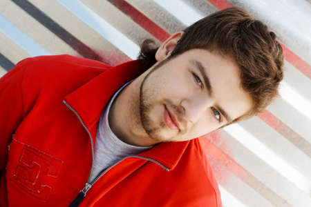 Hansdsome young man in red jacketの写真素材