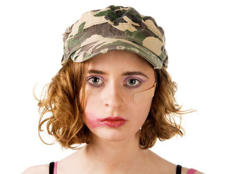 Young woman with smudged makeup an plaster on cheek, white backgroundの写真素材