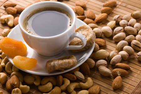 Coffee with nuts, fig and dried apricots still lifeの写真素材