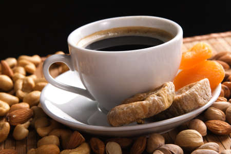 Coffee with nuts, fig and dried apricots still lifeの写真素材