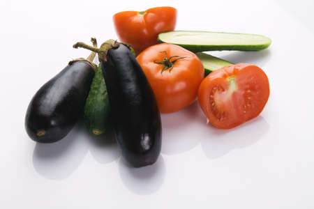Tomatoes and cucumbers on white backgroundの写真素材