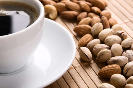 Delicious coffee with nuts on the background の写真素材