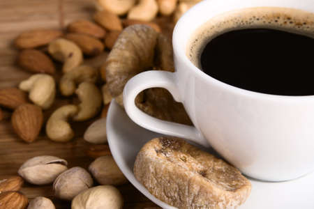 Closeup picture of coffee with nuts and dried fig still life の写真素材
