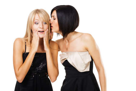 Two young ladies are gossiping 