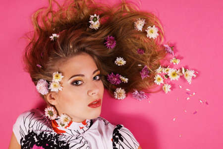 Face portrait of a beautiful fashion model with flowers in hair  の写真素材