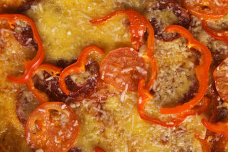 Closeup picture of pizza with salami and paprikaの写真素材