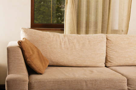Beige comfortable sofa in home interiorの写真素材